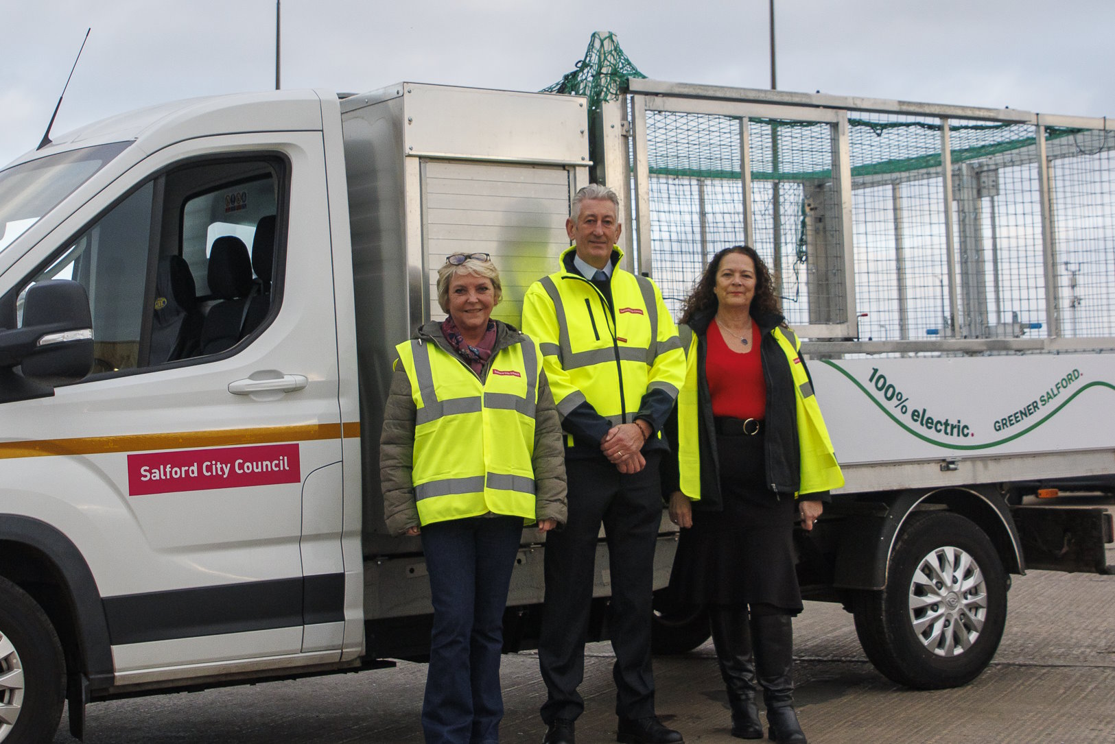 Representatives from Salford City Council stood in front of the new electric truck