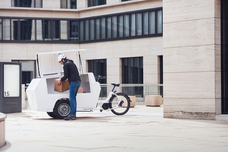 Person lifting box by their cargo bike