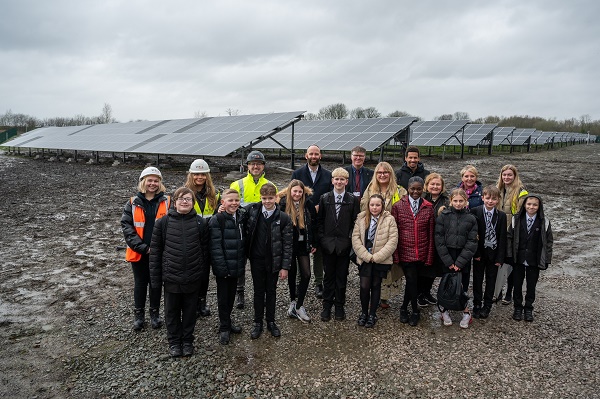 Group of people stood together at solar farm